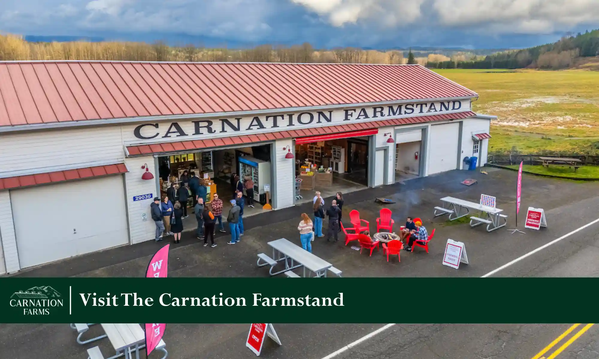 Exterior view of the Carnation Farmstand with visitors shopping for local farm products.