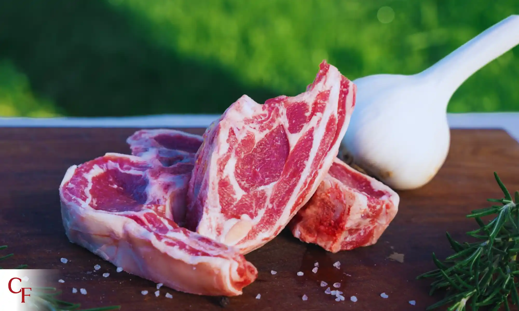 Raw pasture-raised lamb chops with rosemary and garlic