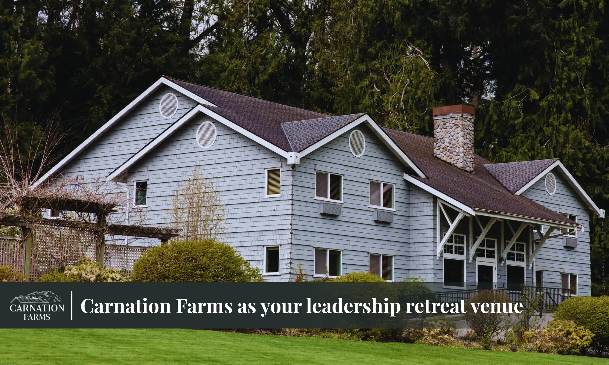 Grey lodge building at Carnation Farms surrounded by trees and greenery