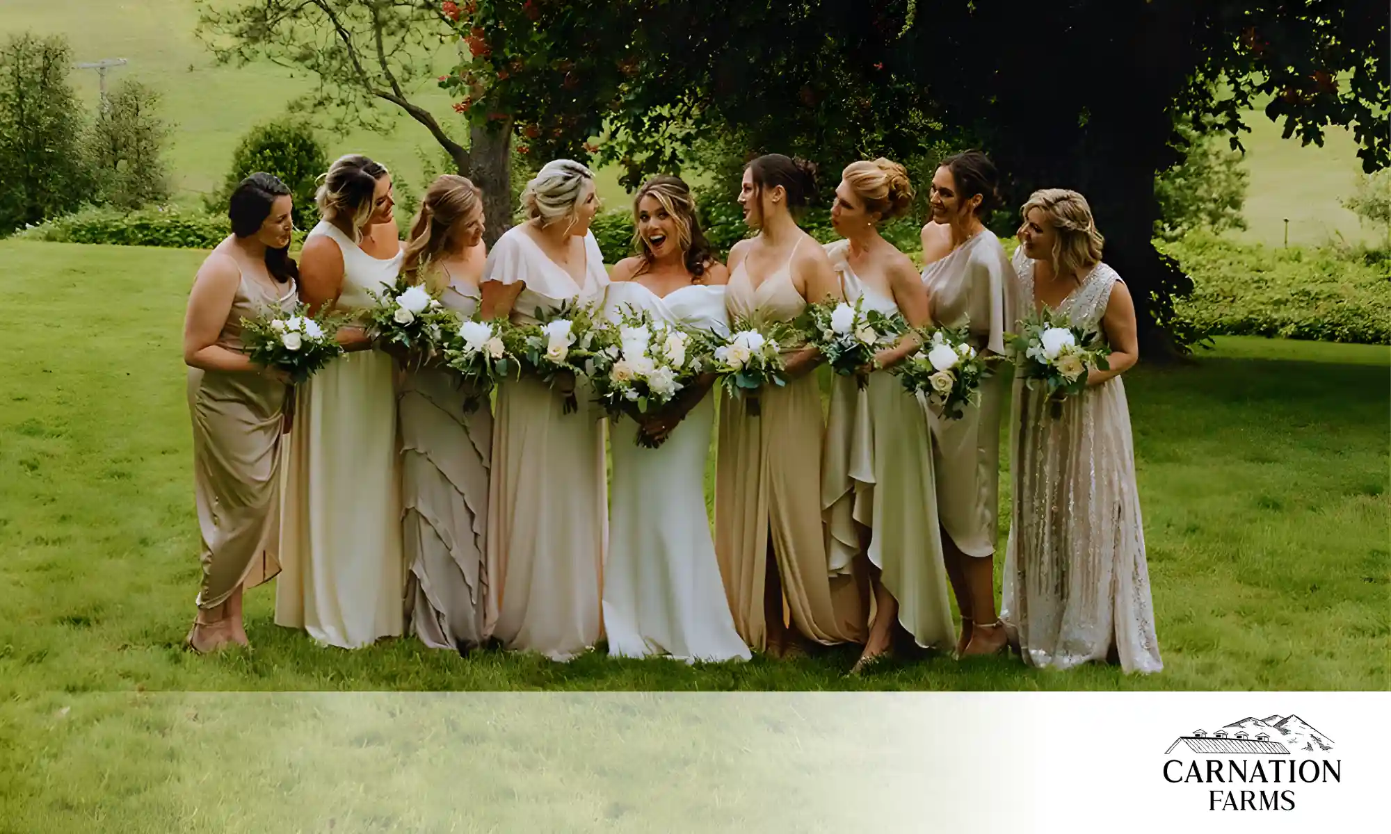 Seattle wedding venue with bridal party standing outdoors at Carnation Farms surrounded by greenery.